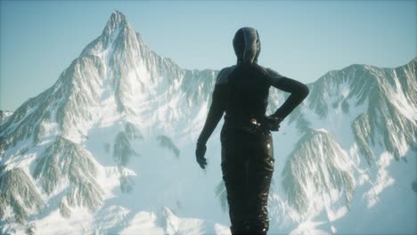 Woman-Standing-In-Snow-Wearing-Warm-Clothes-In-Mountains